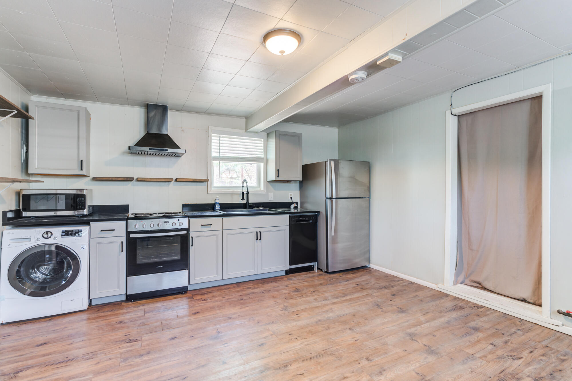 2629 24th Street Lubbock, TX 79410 - Photo 27 of 28 a kitchen with stainless steel appliances granite countertop a stove a refrigerator and a stove top oven