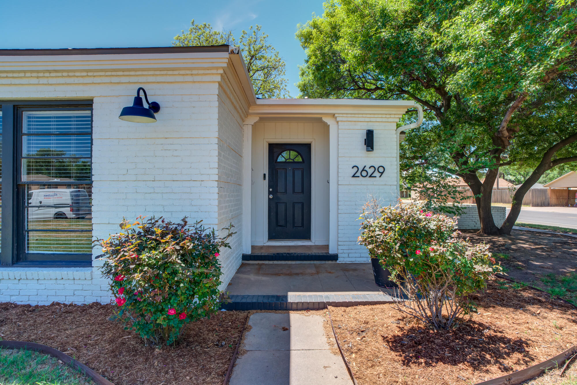 2629 24th Street Lubbock, TX 79410 - Photo 3 of 28 a front view of a house with garden
