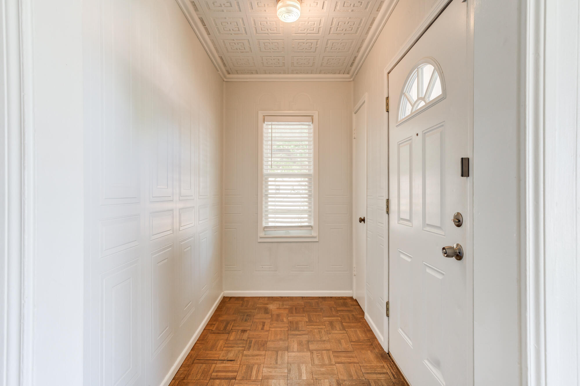 2629 24th Street Lubbock, TX 79410 - Photo 4 of 28 a view of a hallway with wooden floor and a window