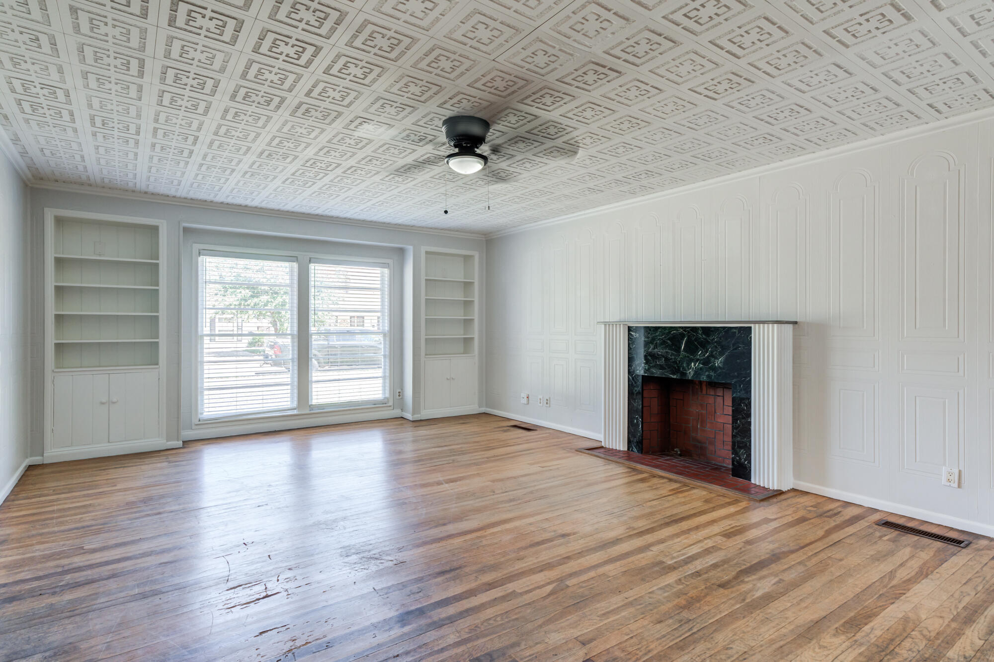 2629 24th Street Lubbock, TX 79410 - Photo 5 of 28 wooden floor in an empty room with a window