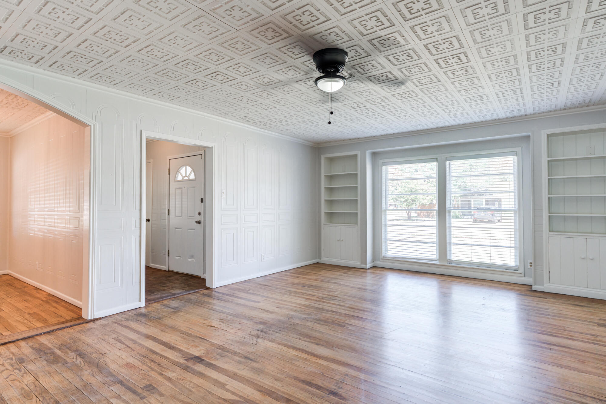2629 24th Street Lubbock, TX 79410 - Photo 6 of 28 an empty room with wooden floor and windows