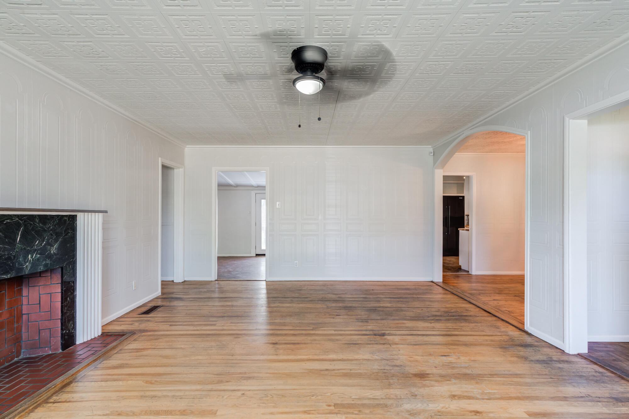 2629 24th Street Lubbock, TX 79410 - Photo 7 of 28 a view of an empty room with wooden floor and a window