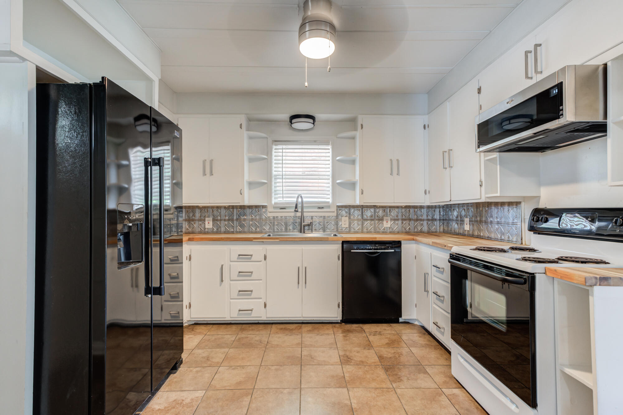 2629 24th Street Lubbock, TX 79410 - Photo 8 of 28 a kitchen with stainless steel appliances granite countertop a stove and a sink