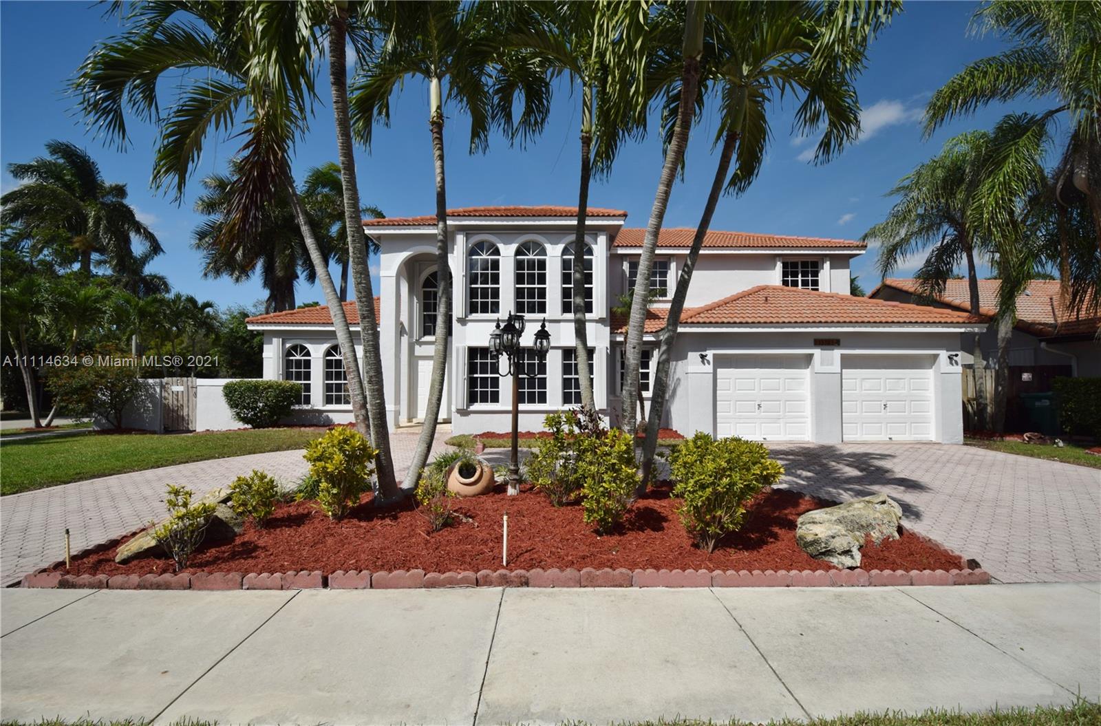 15381 Southwest 112th Terrace Miami, FL 33196 - Photo 2 of 43 a front view of a house with garden