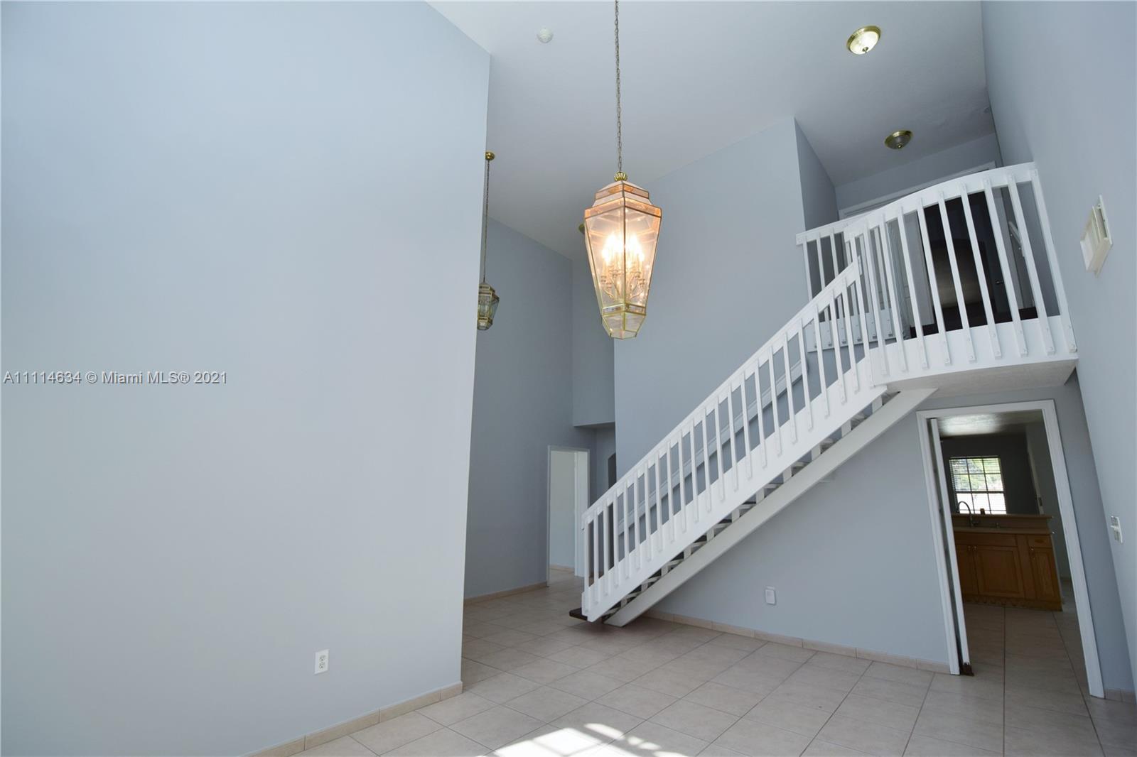 15381 Southwest 112th Terrace Miami, FL 33196 - Photo 11 of 43 a view of staircase with railing and a chandelier