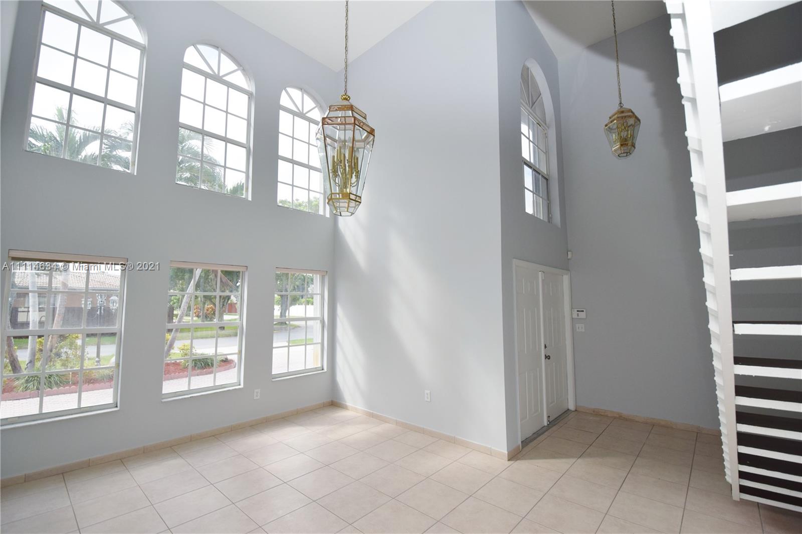 15381 Southwest 112th Terrace Miami, FL 33196 - Photo 12 of 43 a view of an entryway with wooden floor and windows