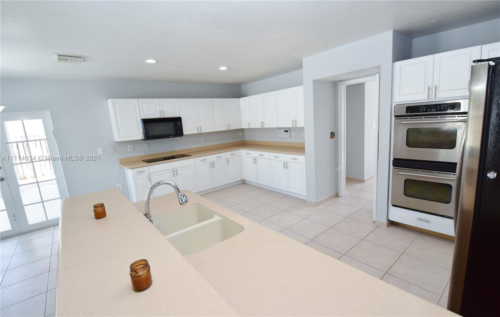 15381 Southwest 112th Terrace Miami, FL 33196 - Photo 15 of 43 a kitchen with a sink appliances and cabinets