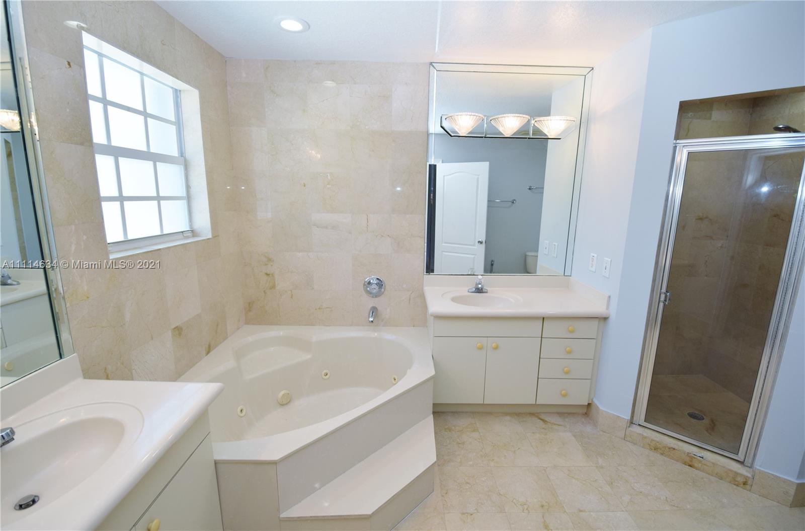 15381 Southwest 112th Terrace Miami, FL 33196 - Photo 18 of 43 a bathroom with a tub sink and mirror