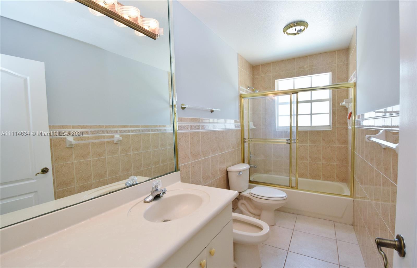 15381 Southwest 112th Terrace Miami, FL 33196 - Photo 27 of 43 a bathroom with a sink a toilet and shower