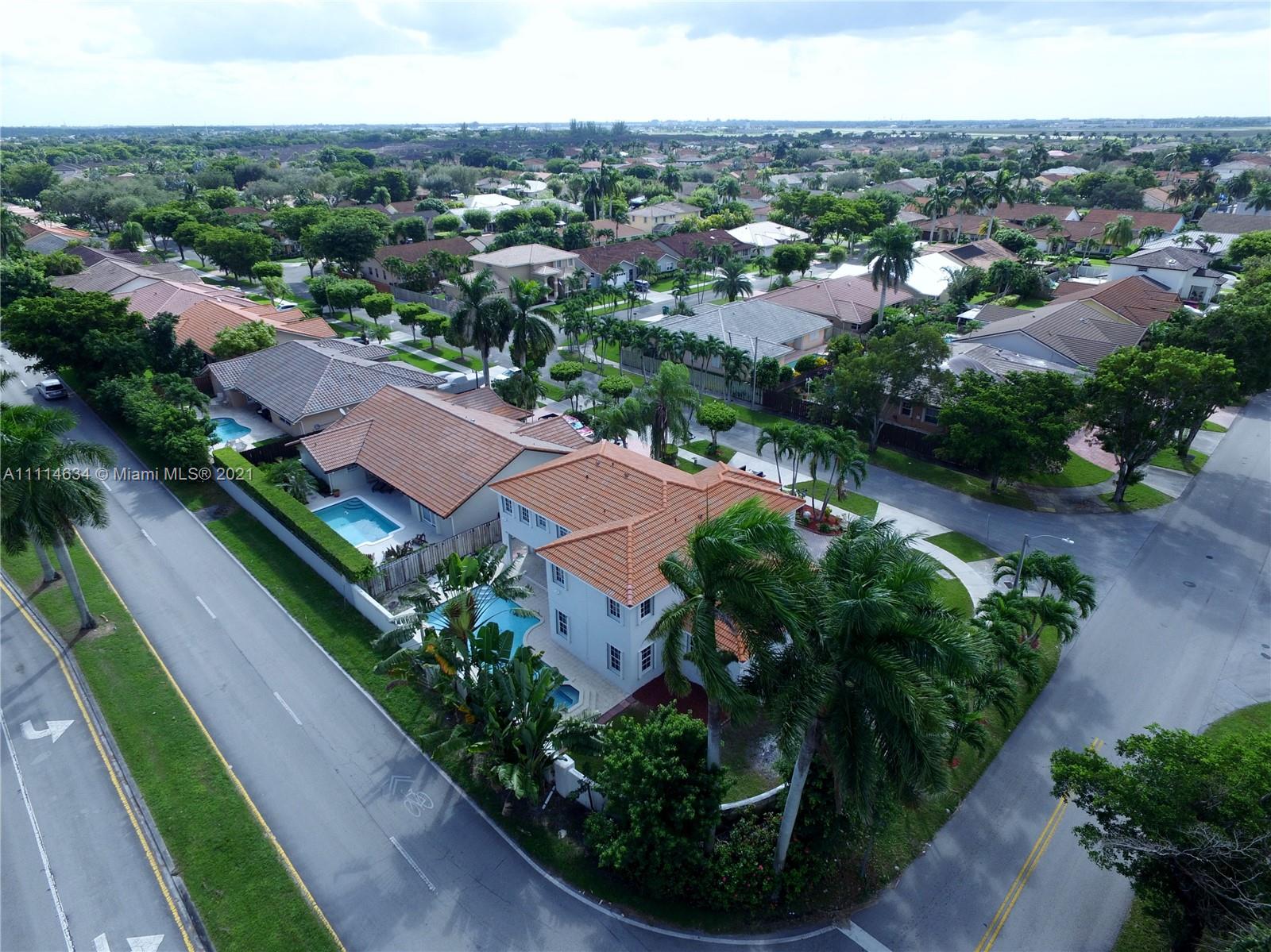 15381 Southwest 112th Terrace Miami, FL 33196 - Photo 4 of 43 an aerial view of a city with lots of residential buildings