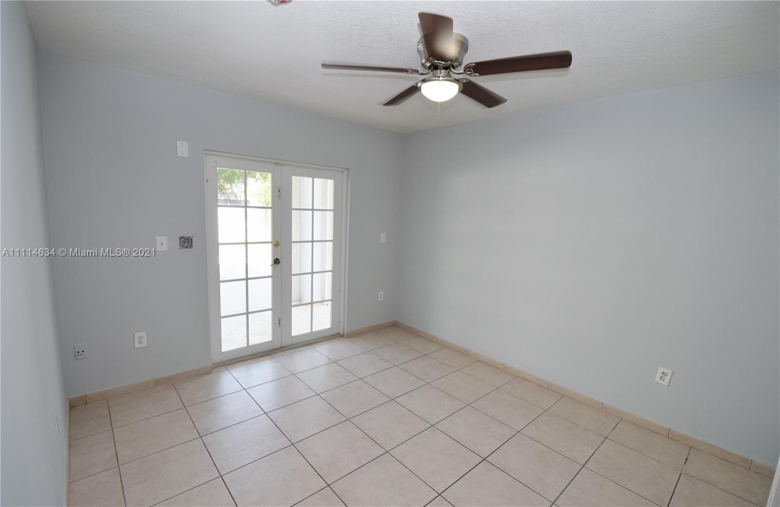 15381 Southwest 112th Terrace Miami, FL 33196 - Photo 36 of 43 an empty room with windows and fan