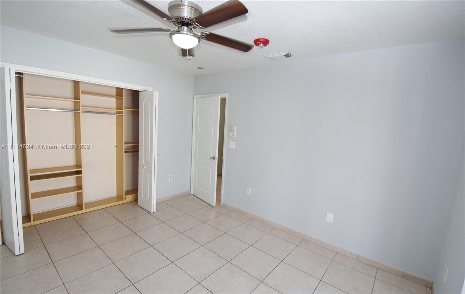 15381 Southwest 112th Terrace Miami, FL 33196 - Photo 37 of 43 an empty room with closet and ceiling fan