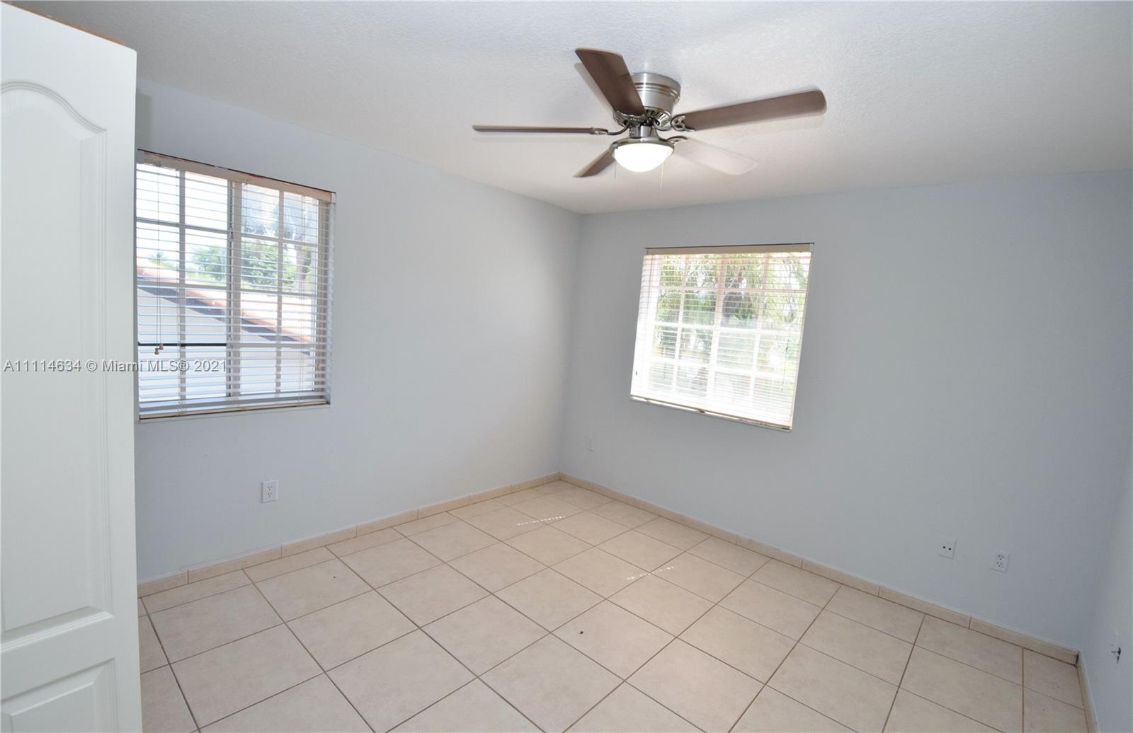 15381 Southwest 112th Terrace Miami, FL 33196 - Photo 38 of 43 an empty room with windows and fan