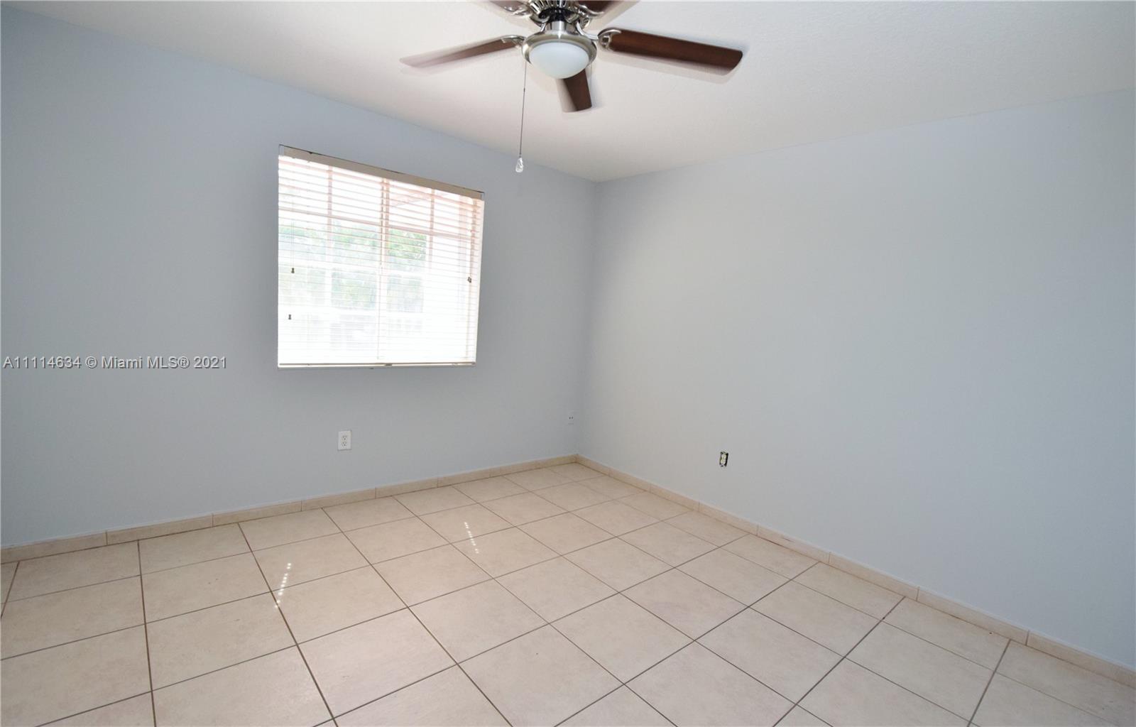 15381 Southwest 112th Terrace Miami, FL 33196 - Photo 40 of 43 an empty room with windows and fan