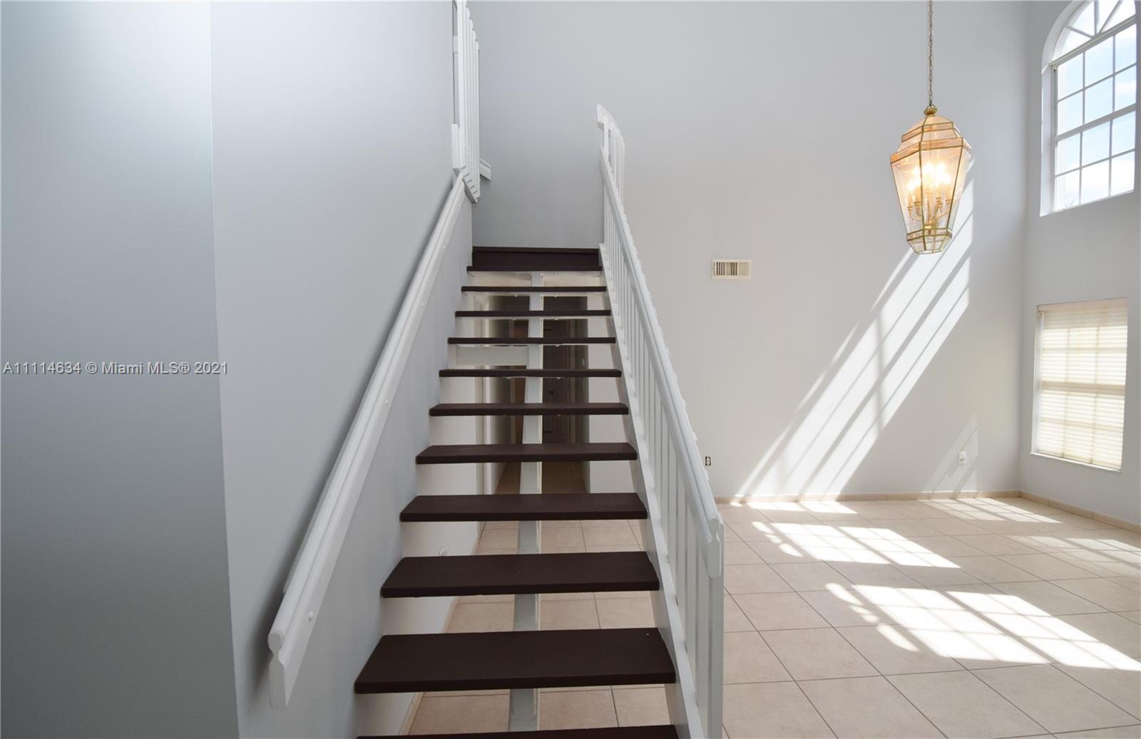 15381 Southwest 112th Terrace Miami, FL 33196 - Photo 8 of 43 a view of staircase with white walls and a window