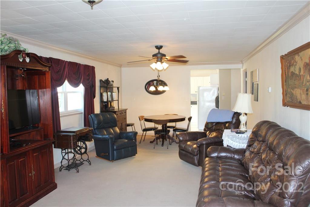 77 Floyd Blackwell Road Tryon, NC 28782 - Photo 21 of 32 a living room with furniture a chandelier and a window