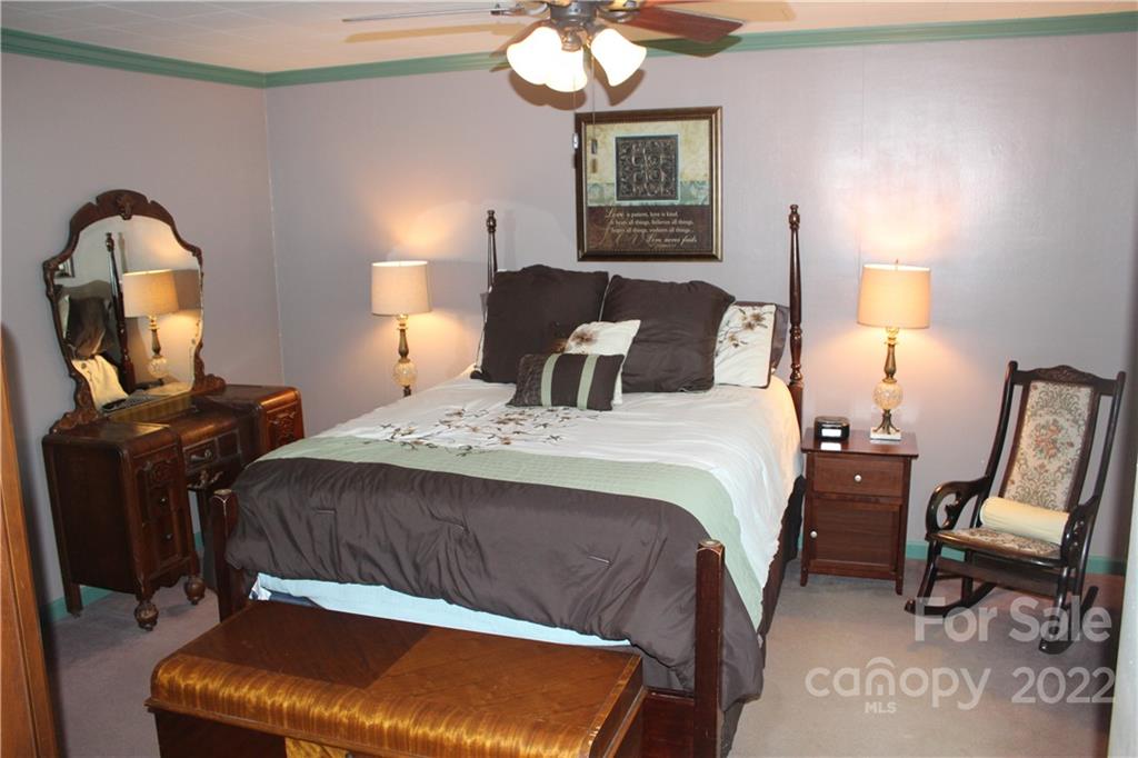 77 Floyd Blackwell Road Tryon, NC 28782 - Photo 24 of 32 a bedroom with a bed and a mirror