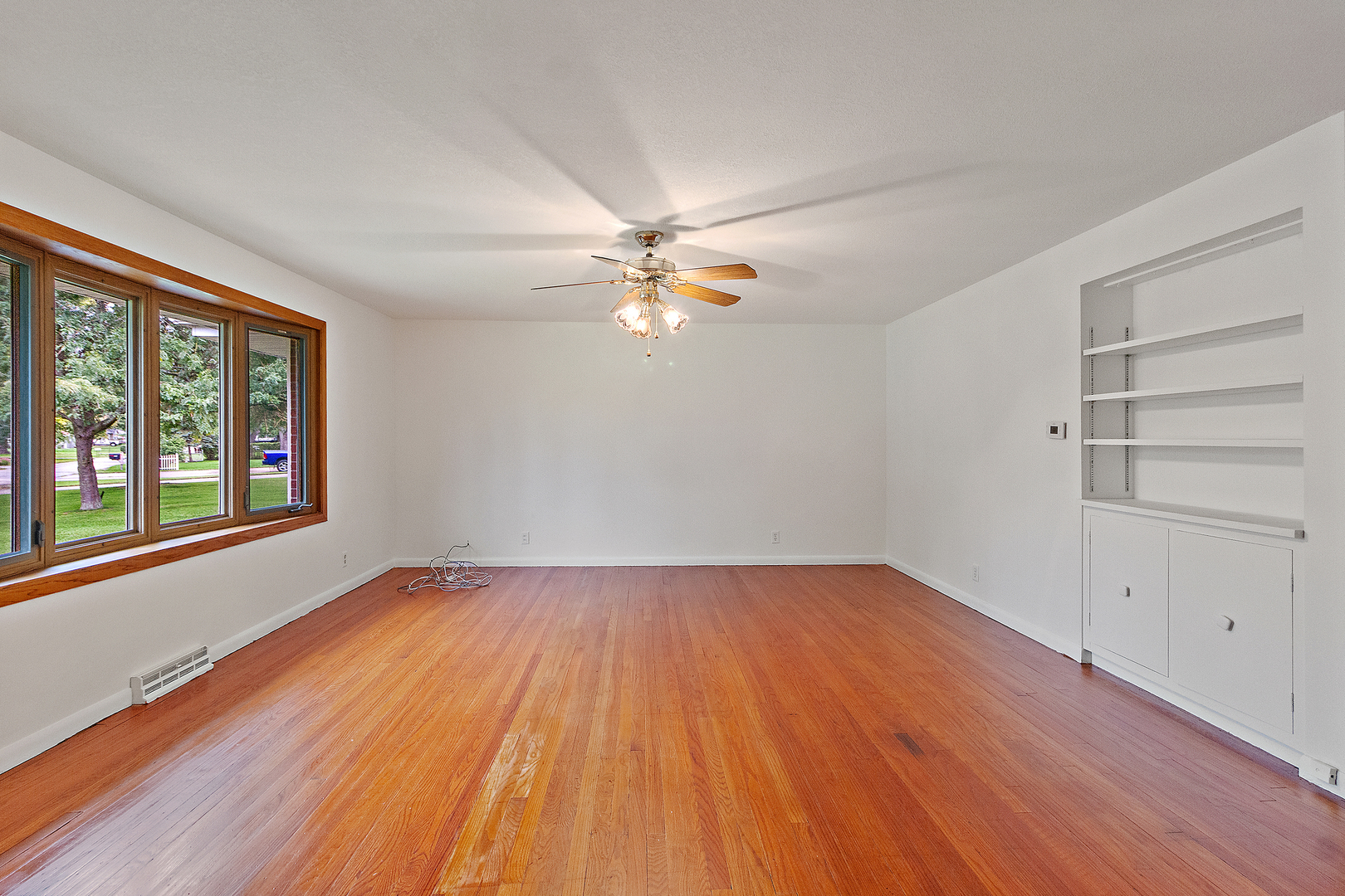 19 Durell Drive Kankakee, IL 60901 - Photo 3 of 25 wooden floor in an empty room with a window