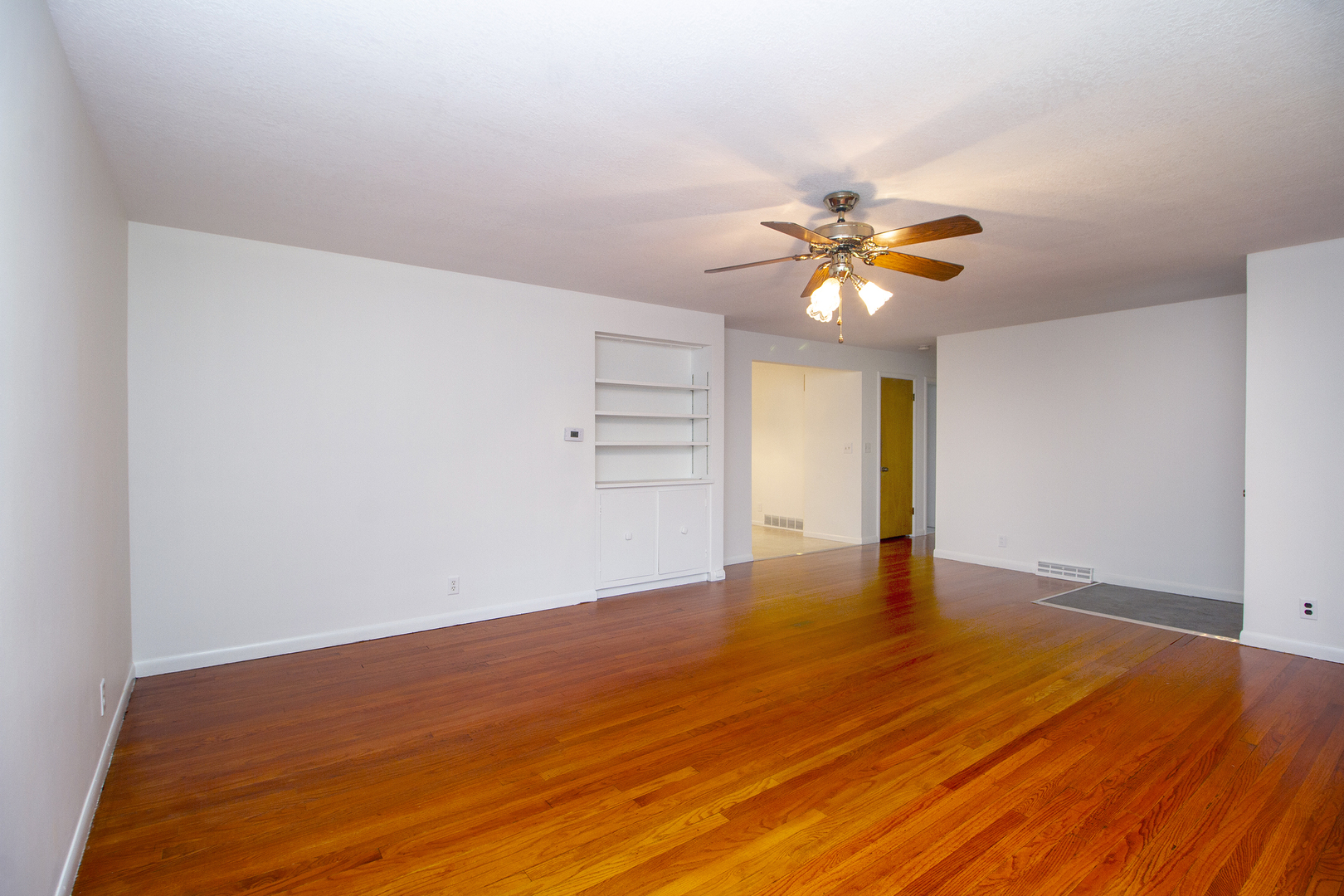 19 Durell Drive Kankakee, IL 60901 - Photo 4 of 25 a view of empty room with wooden floor and fan