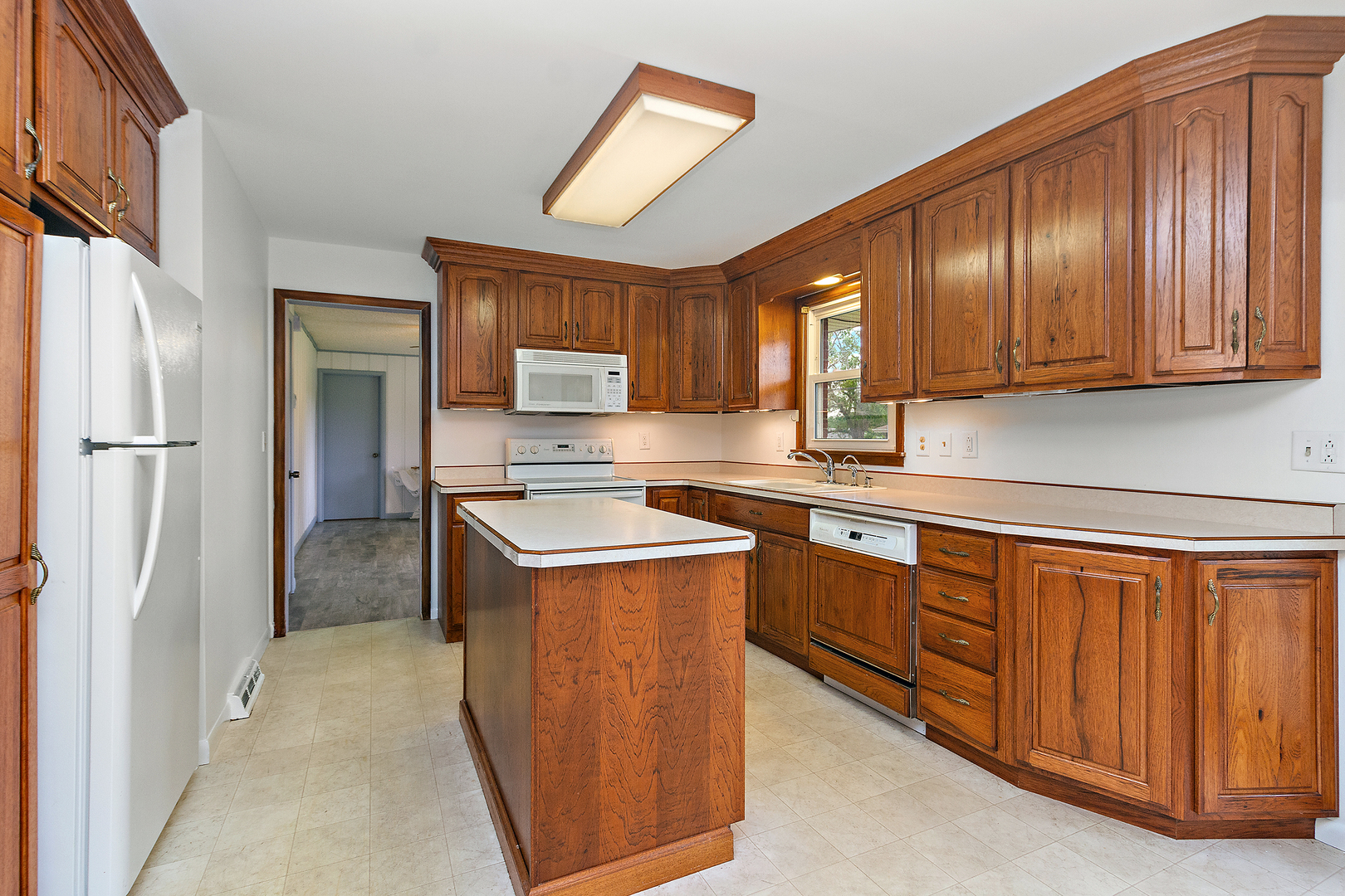 19 Durell Drive Kankakee, IL 60901 - Photo 5 of 25 a kitchen with stainless steel appliances granite countertop wooden cabinets a sink and a refrigerator