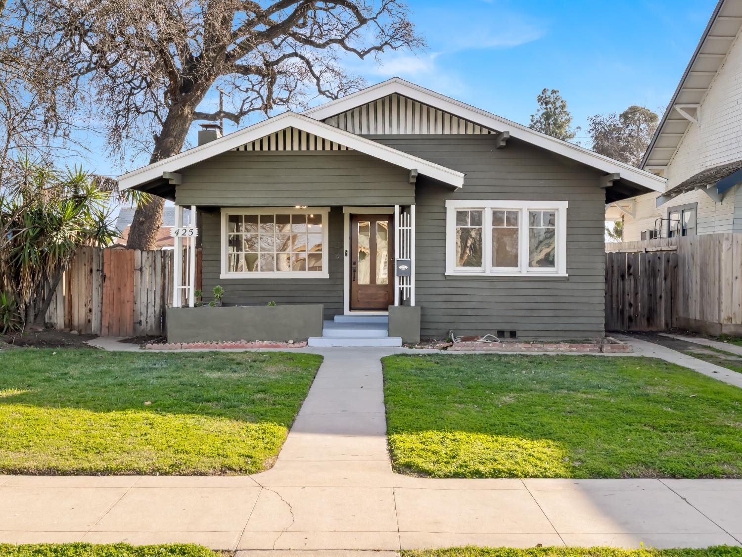 425 West Elm Street Hanford, CA 93230 - Photo 2 of 18 a front view of a house with a yard