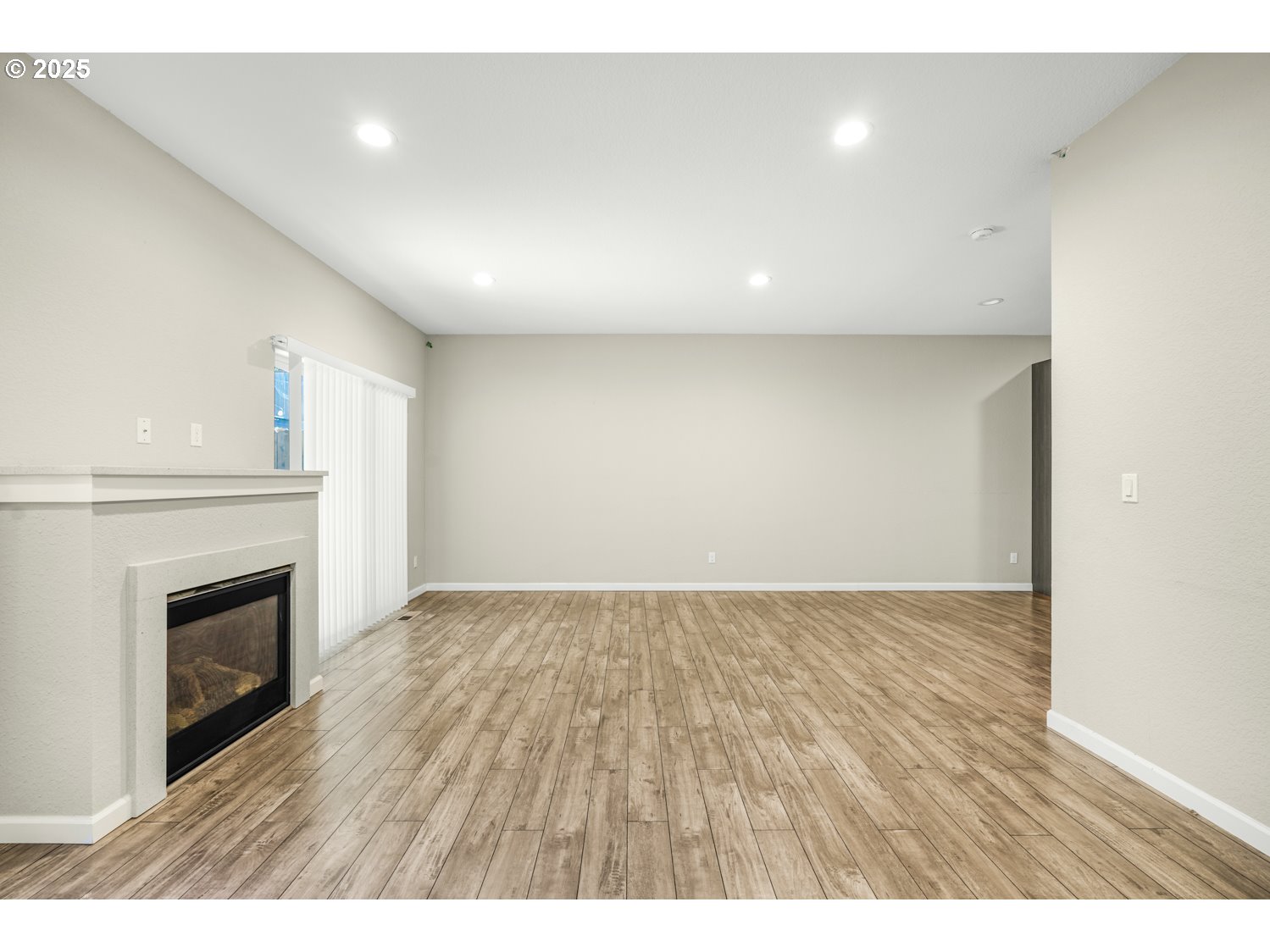 3804 Nicholson Road Vancouver, WA 98661 - Photo 5 of 24 a view of an empty room with wooden floor and fireplace