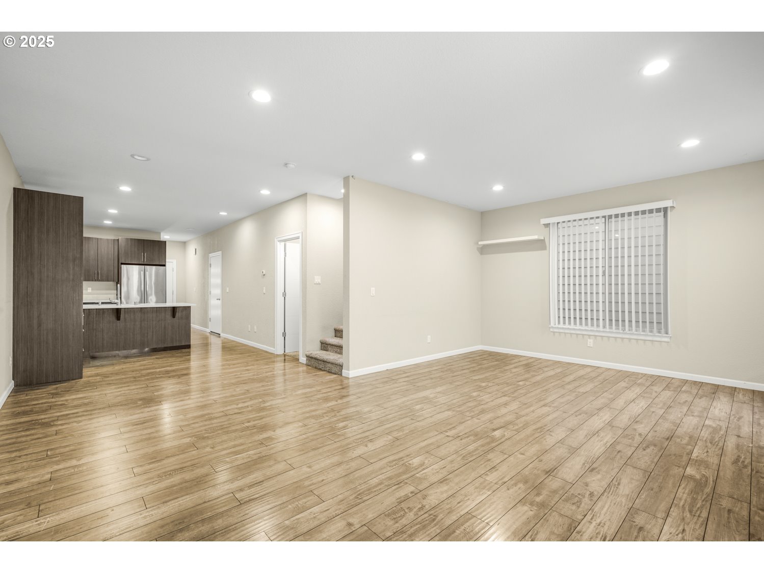 3804 Nicholson Road Vancouver, WA 98661 - Photo 6 of 24 a view of an empty room with wooden floor and kitchen
