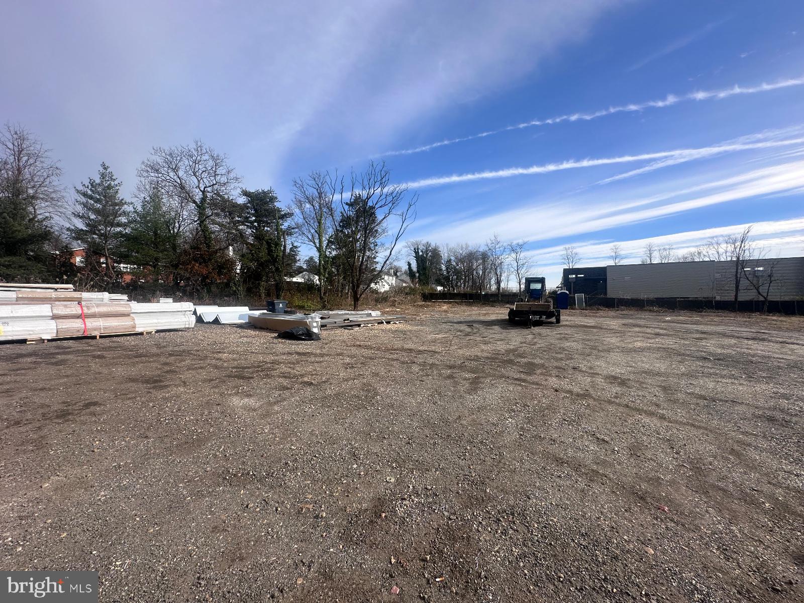 a view of a field with trees in the background