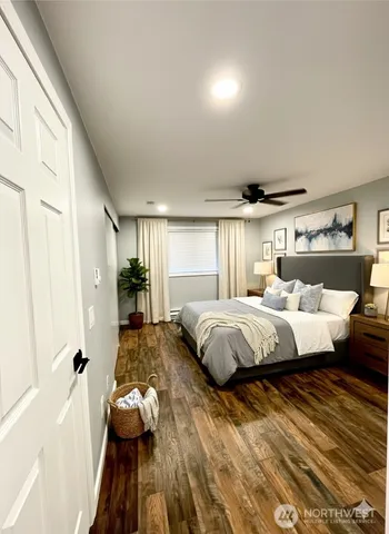 a spacious bedroom with a bed and a chandelier