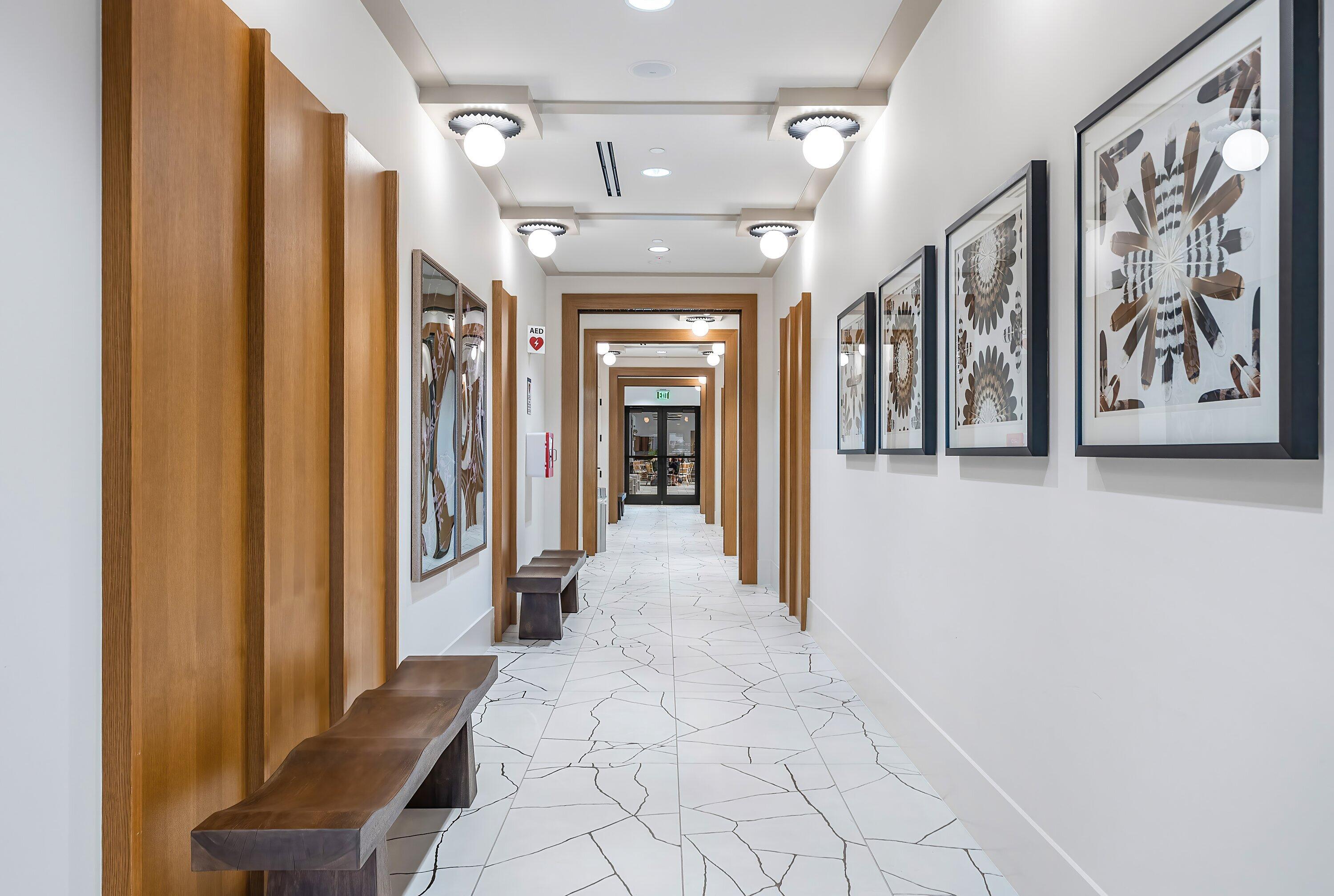 20197 Castle Stuart Avenue Boca Raton, FL 33434 - Photo 31 of 43 a view of a hallway with paintings on the wall