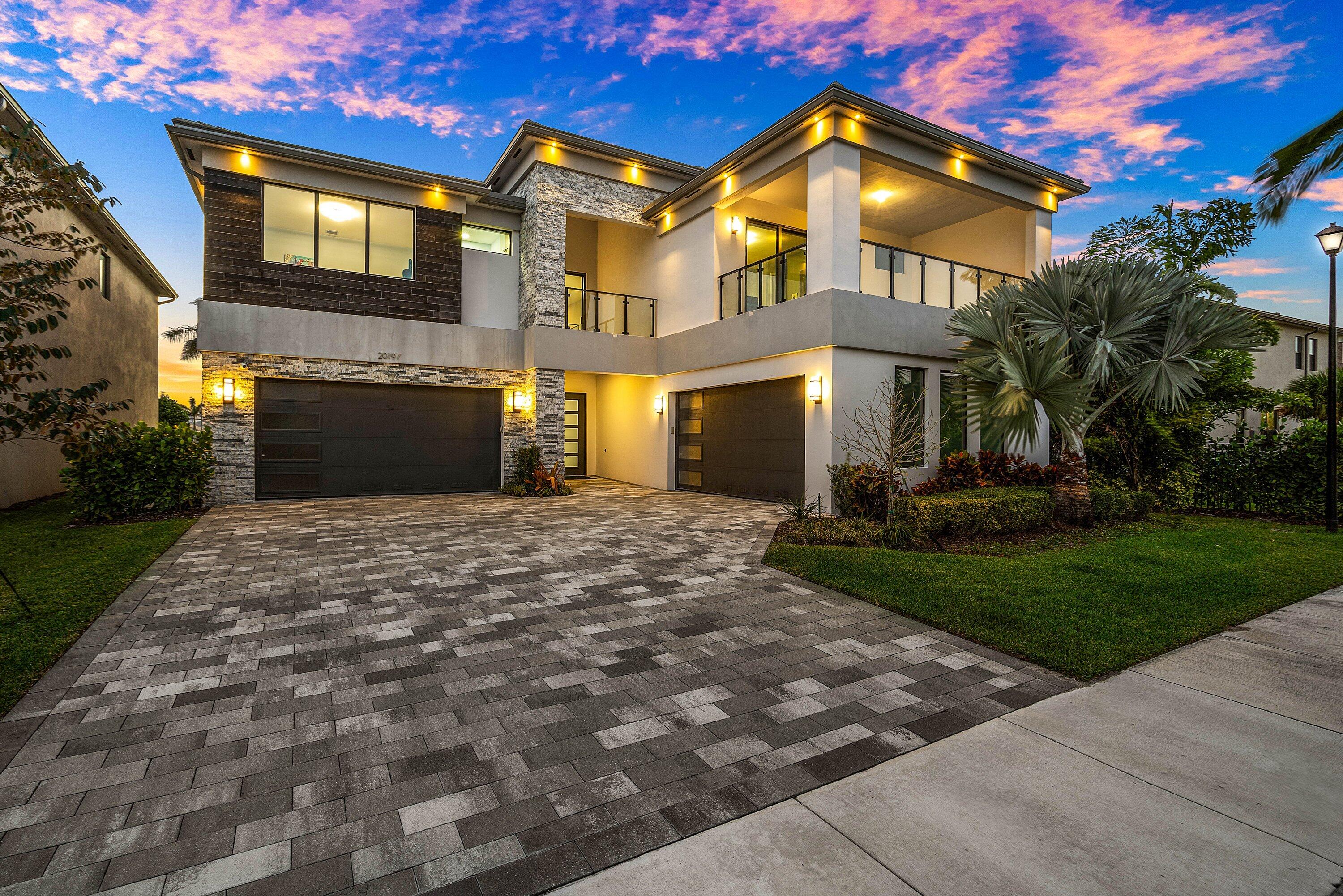 20197 Castle Stuart Avenue Boca Raton, FL 33434 - Photo 43 of 43 a front view of a house with a garden