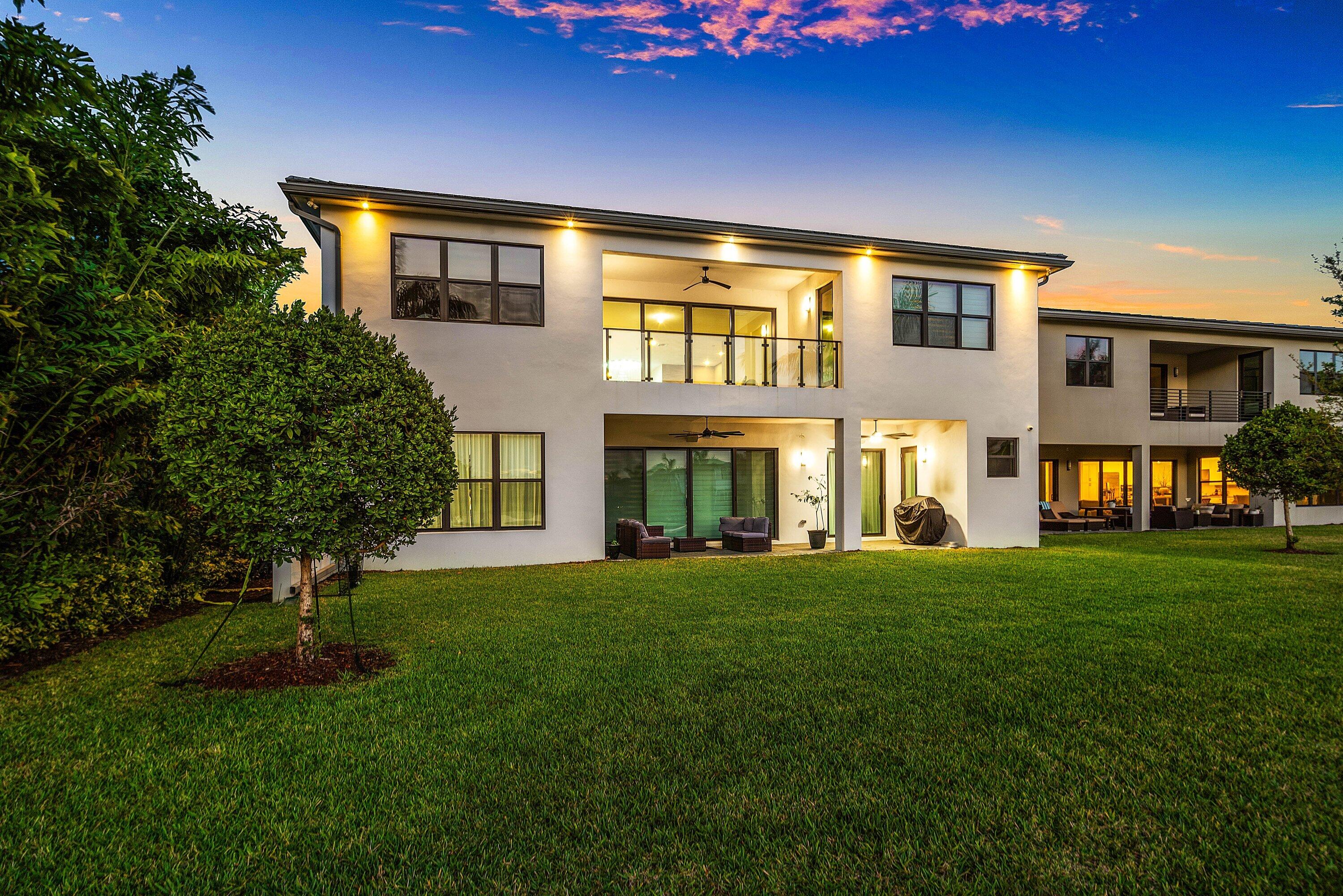 20197 Castle Stuart Avenue Boca Raton, FL 33434 - Photo 6 of 43 a front view of a house with a garden