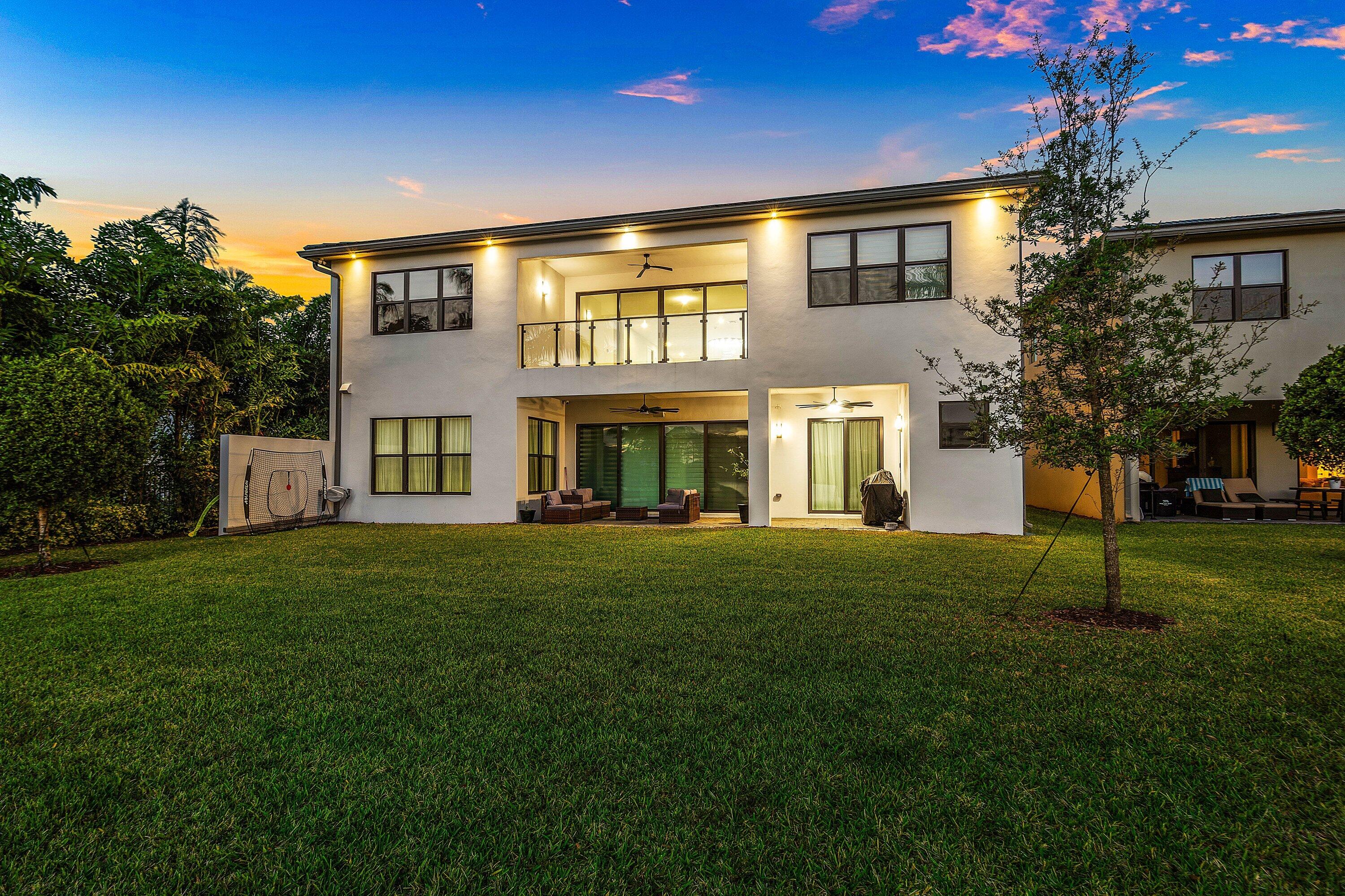 20197 Castle Stuart Avenue Boca Raton, FL 33434 - Photo 7 of 43 a front view of a house with a garden