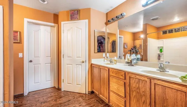 a bathroom with a double vanity sink and a mirror