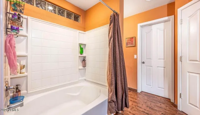 a bathroom with a bathtub and shower