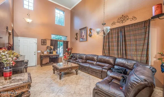 a living room with furniture and flowers