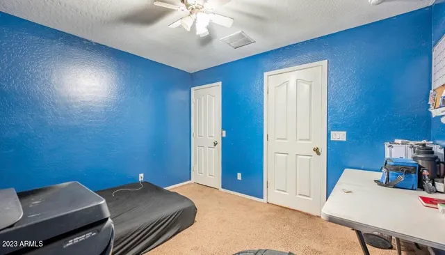 a bed room with a bed and a chair