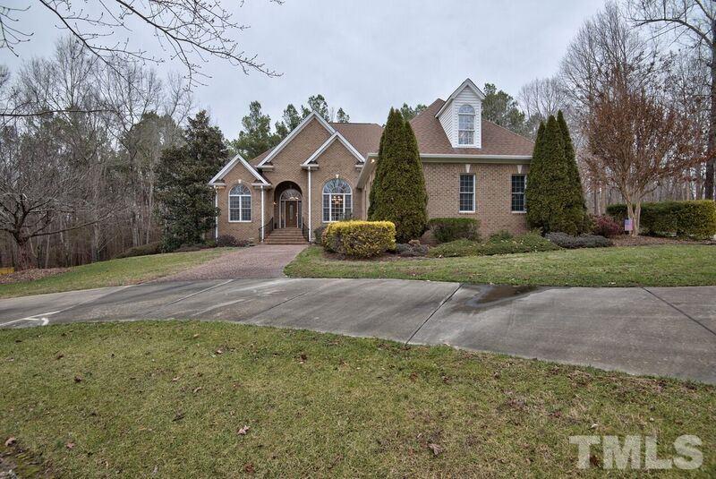 1815 Helena Moriah Road Timberlake, NC 27583 - Photo 1 of 23 a front view of a house with a yard and garage