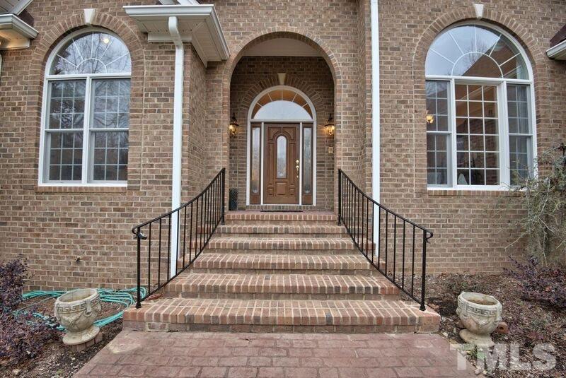 1815 Helena Moriah Road Timberlake, NC 27583 - Photo 2 of 23 a view of a brick house with many windows