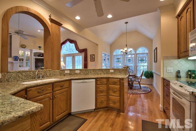 1815 Helena Moriah Road Timberlake, NC 27583 - Photo 12 of 23 a large kitchen with granite countertop a stove a sink dishwasher and a dining table with garden view