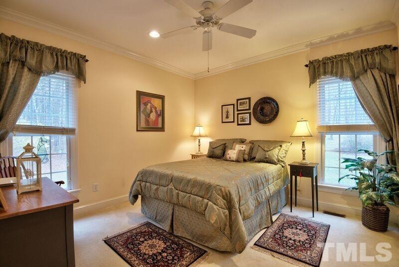 1815 Helena Moriah Road Timberlake, NC 27583 - Photo 16 of 23 a bedroom with a bed and a potted plant