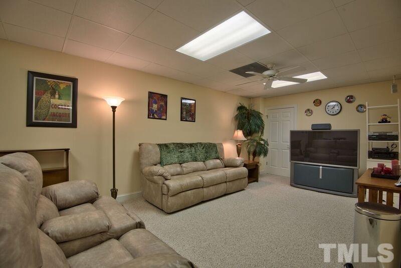 1815 Helena Moriah Road Timberlake, NC 27583 - Photo 18 of 23 a living room with furniture and a flat screen tv