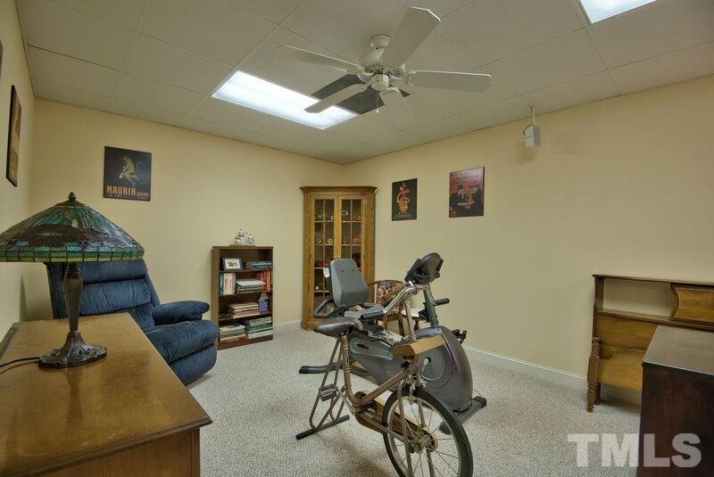 1815 Helena Moriah Road Timberlake, NC 27583 - Photo 20 of 23 a living room with furniture and a flat screen tv