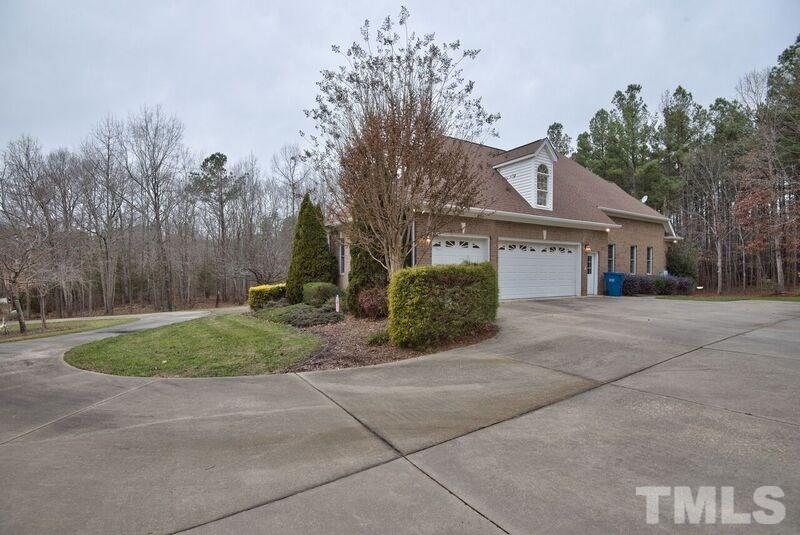 1815 Helena Moriah Road Timberlake, NC 27583 - Photo 4 of 23 a front view of a house with a yard and a garage