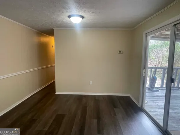 a view of a room with wooden floor and windows