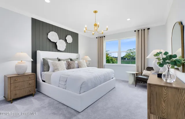 a bedroom with bed and a chandelier