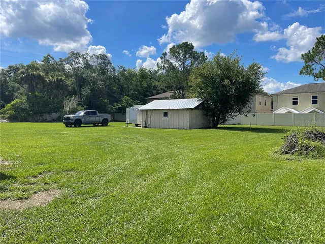 a view of a house with a yard and sitting area