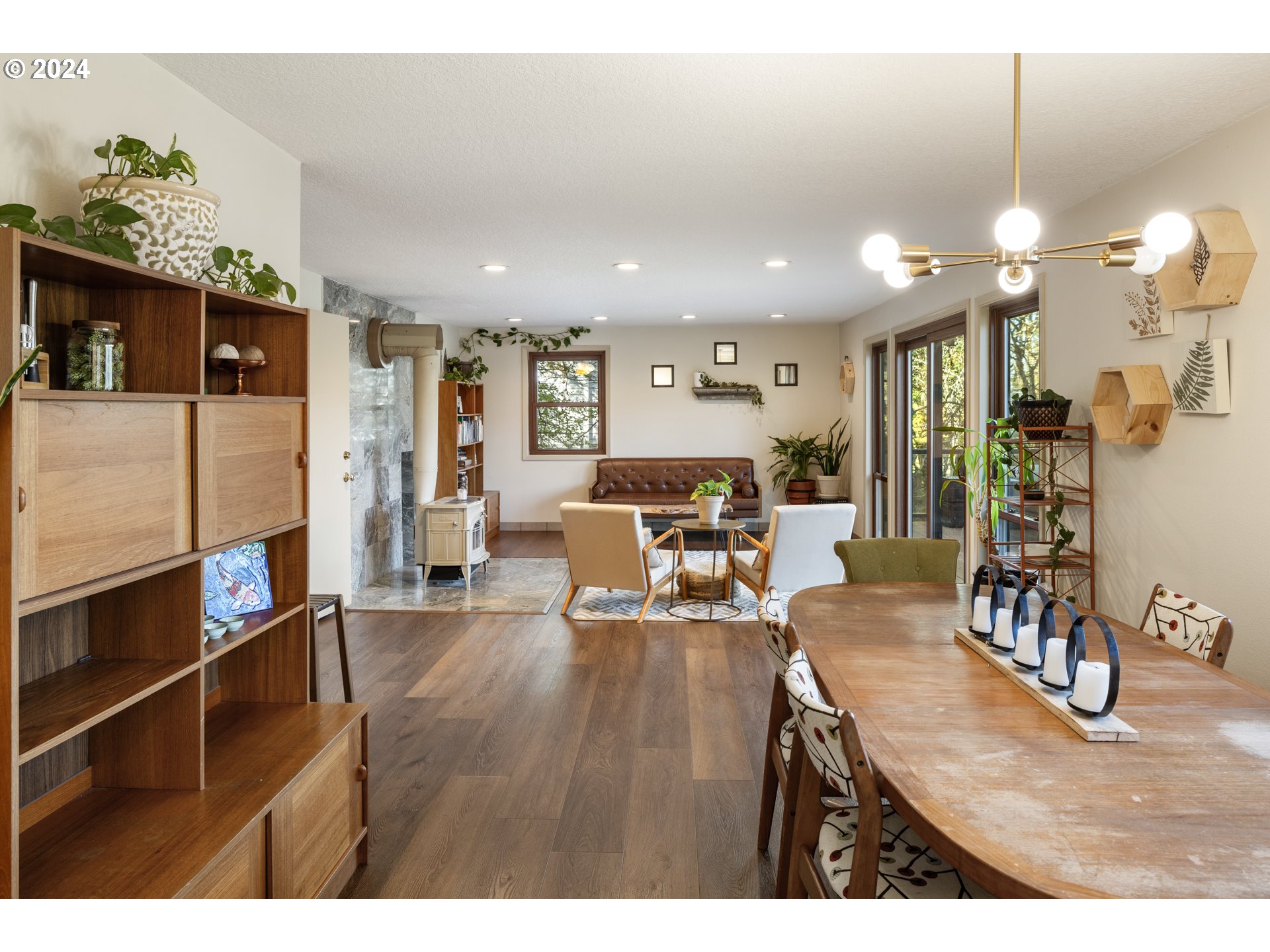 4335 Southwest Cullen Boulevard Portland, OR 97221 - Photo 12 of 46 a living room with furniture kitchen and a chandelier