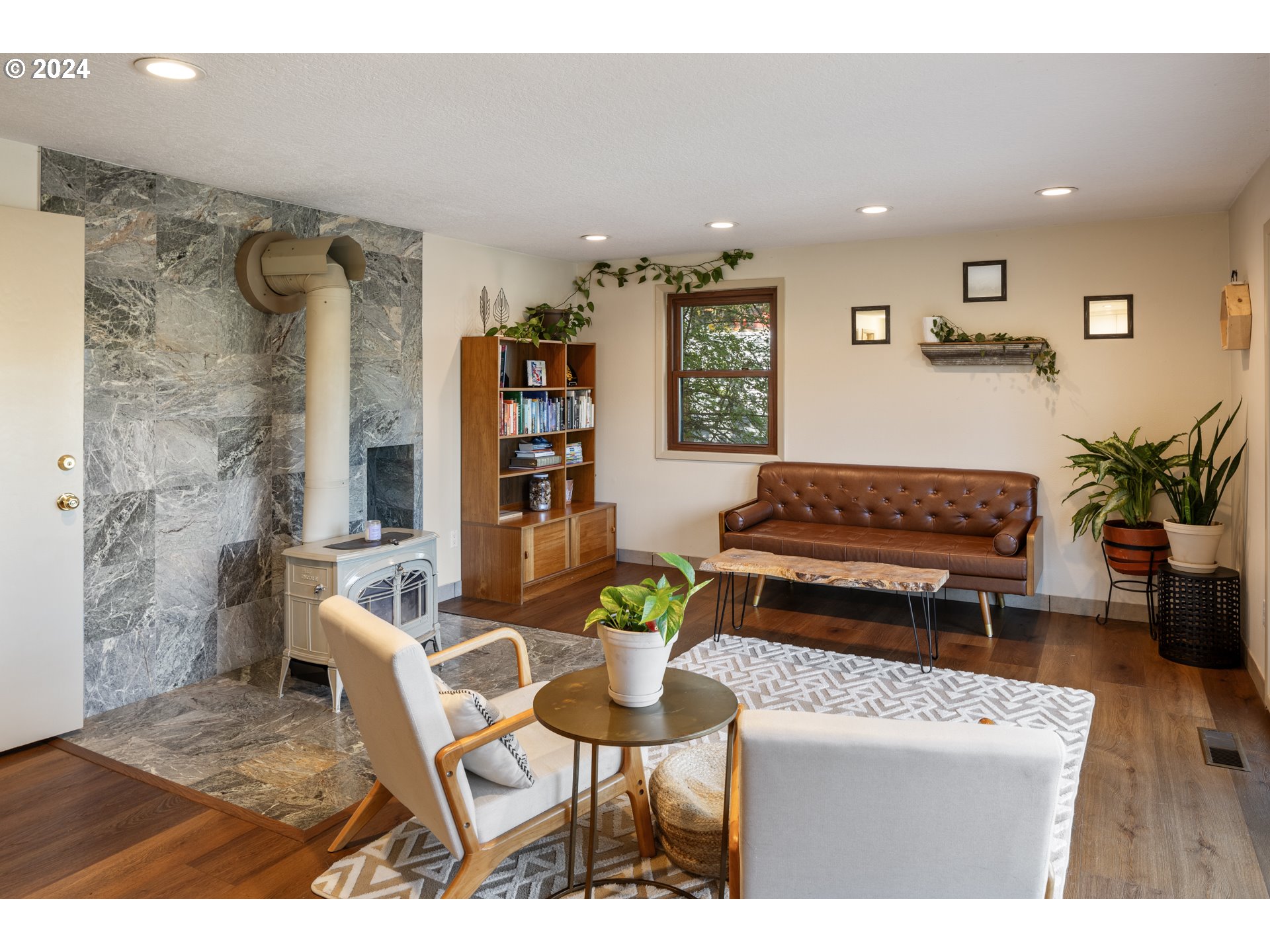 4335 Southwest Cullen Boulevard Portland, OR 97221 - Photo 15 of 46 a living room with furniture and a dining table with potted plant