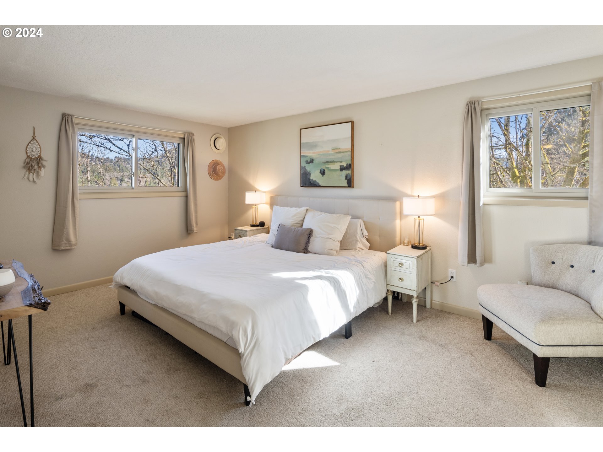 4335 Southwest Cullen Boulevard Portland, OR 97221 - Photo 17 of 46 a bedroom with a bed a mirror and a large window